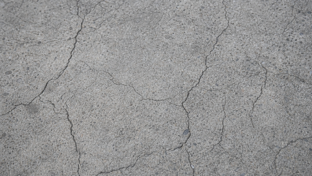 Photorealistic close up of a cracked concrete surf 1788530385556 1